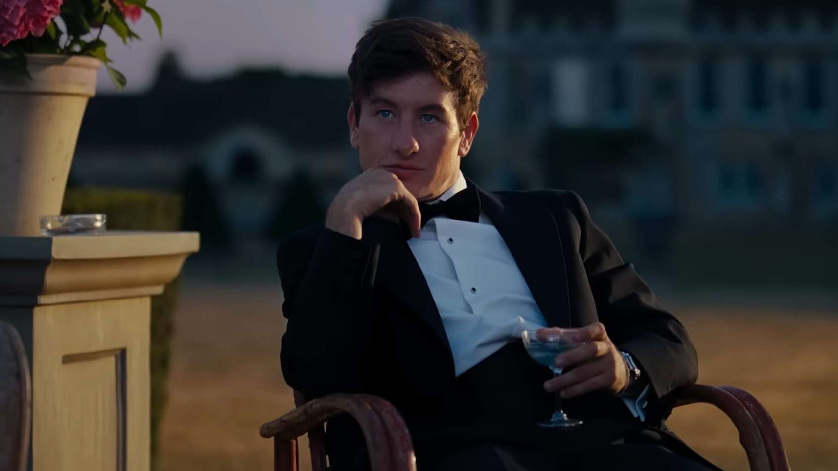 Barry Keoghan in a tuxedo with a cocktail drink