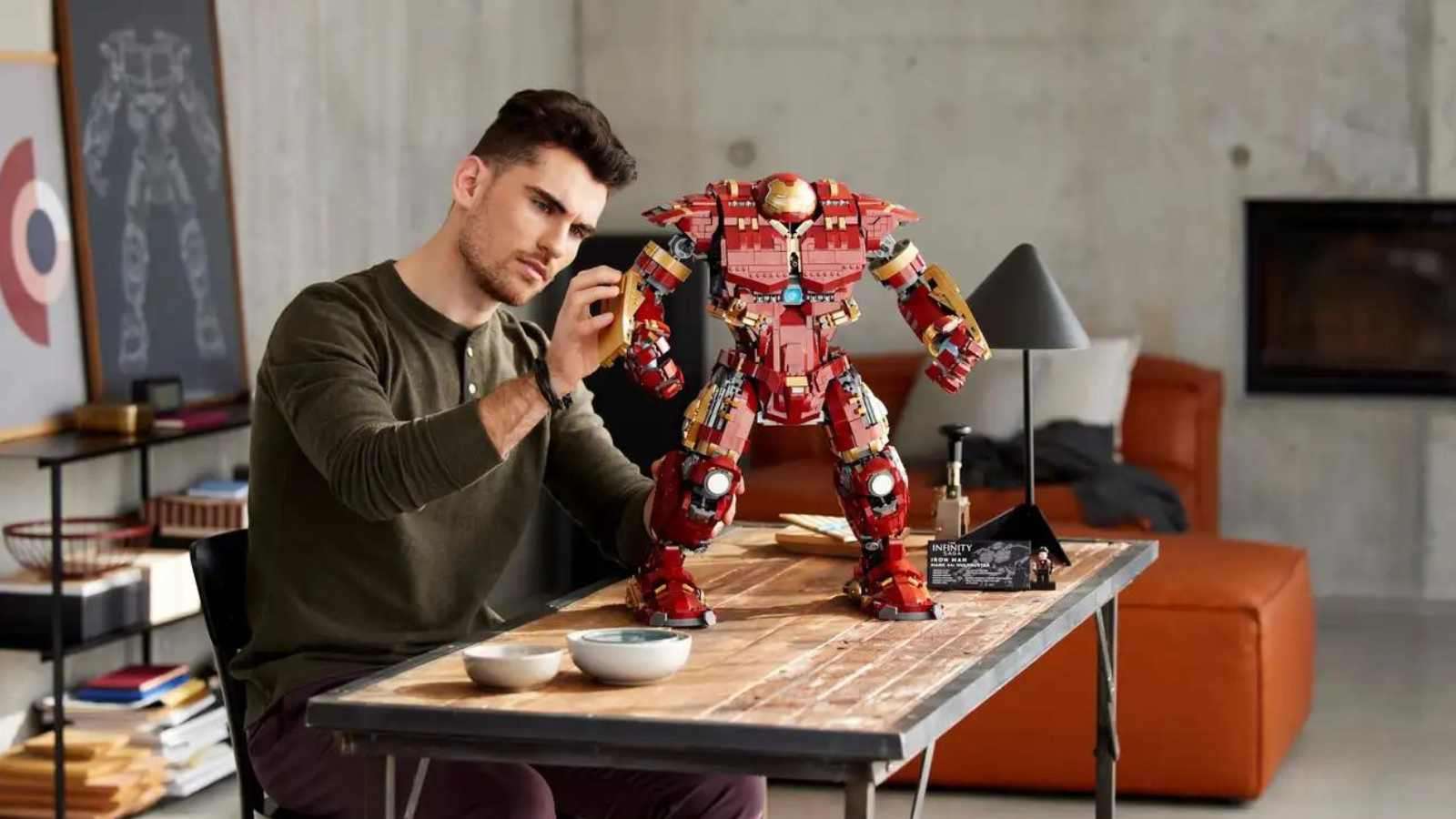 An adult with their LEGO Marvel Hulkbuster set.