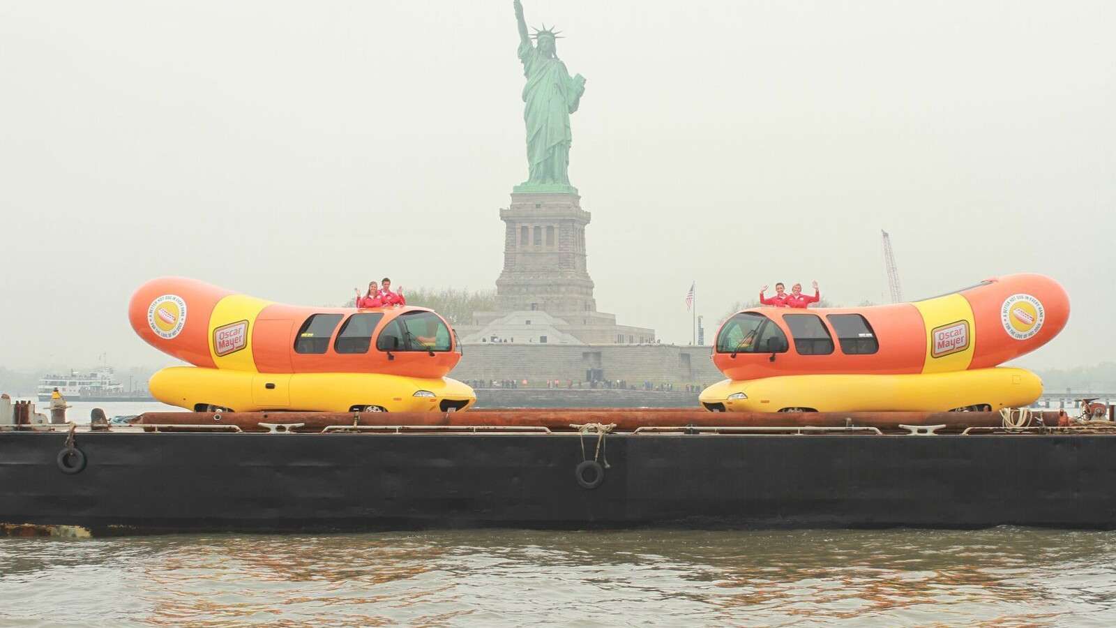 Oscar Mayer wienermobiles at the Statue of LIberty