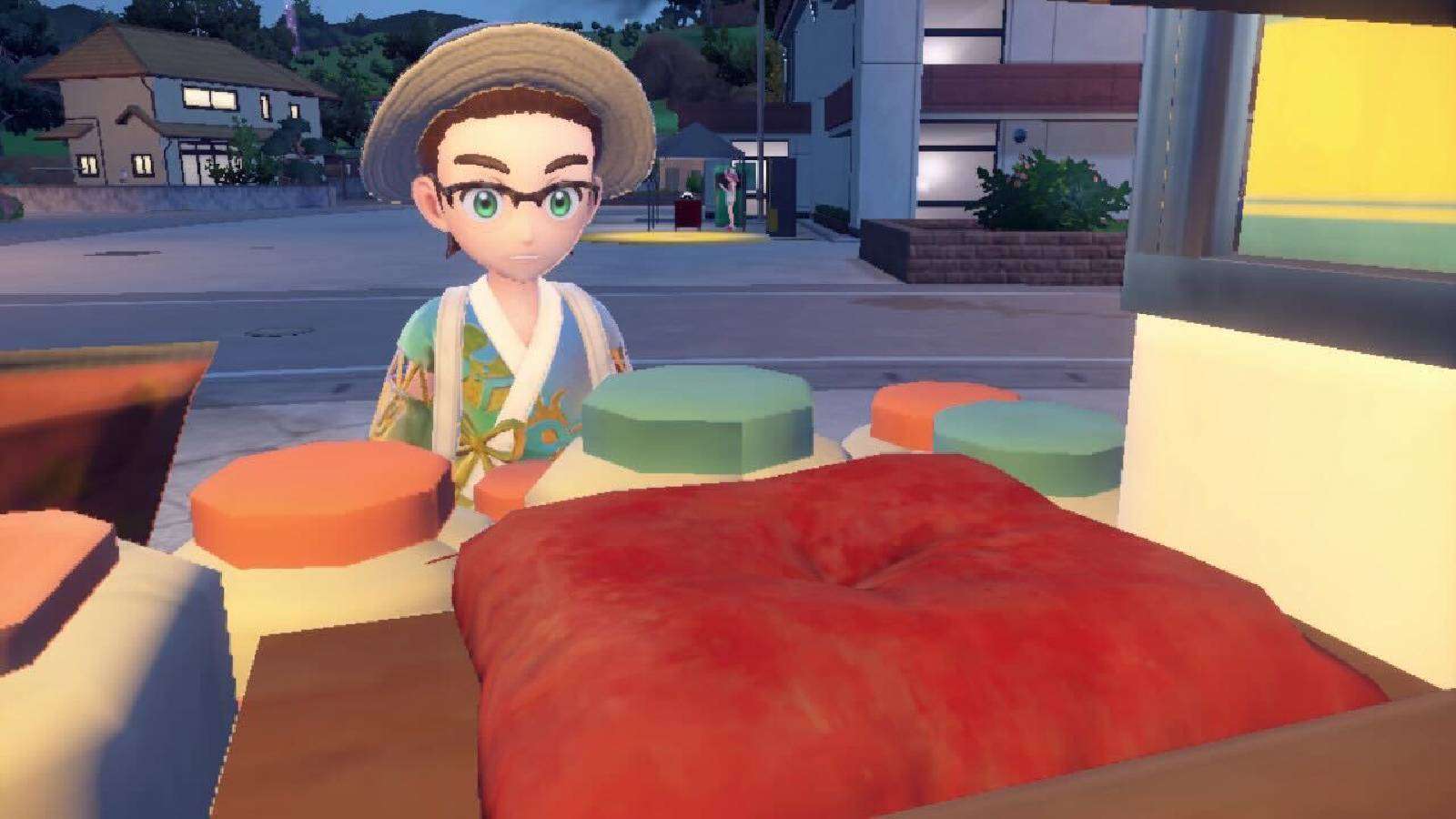A Pokemon trainer looks at an empty red pillow