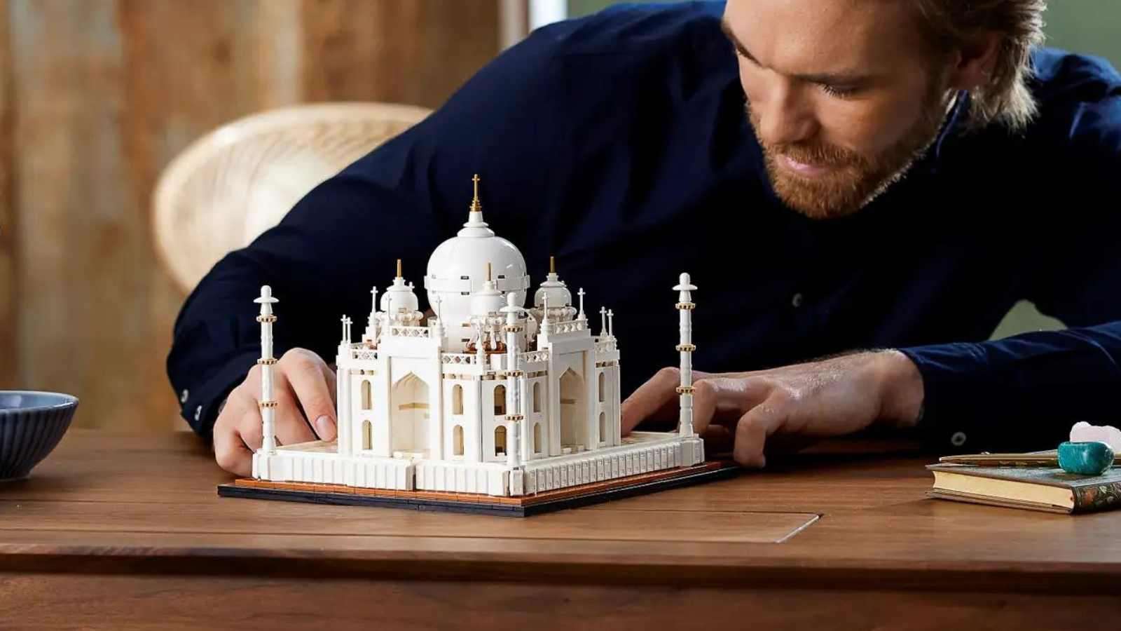 An adult admiring their LEGO Architecture Taj Mahal set