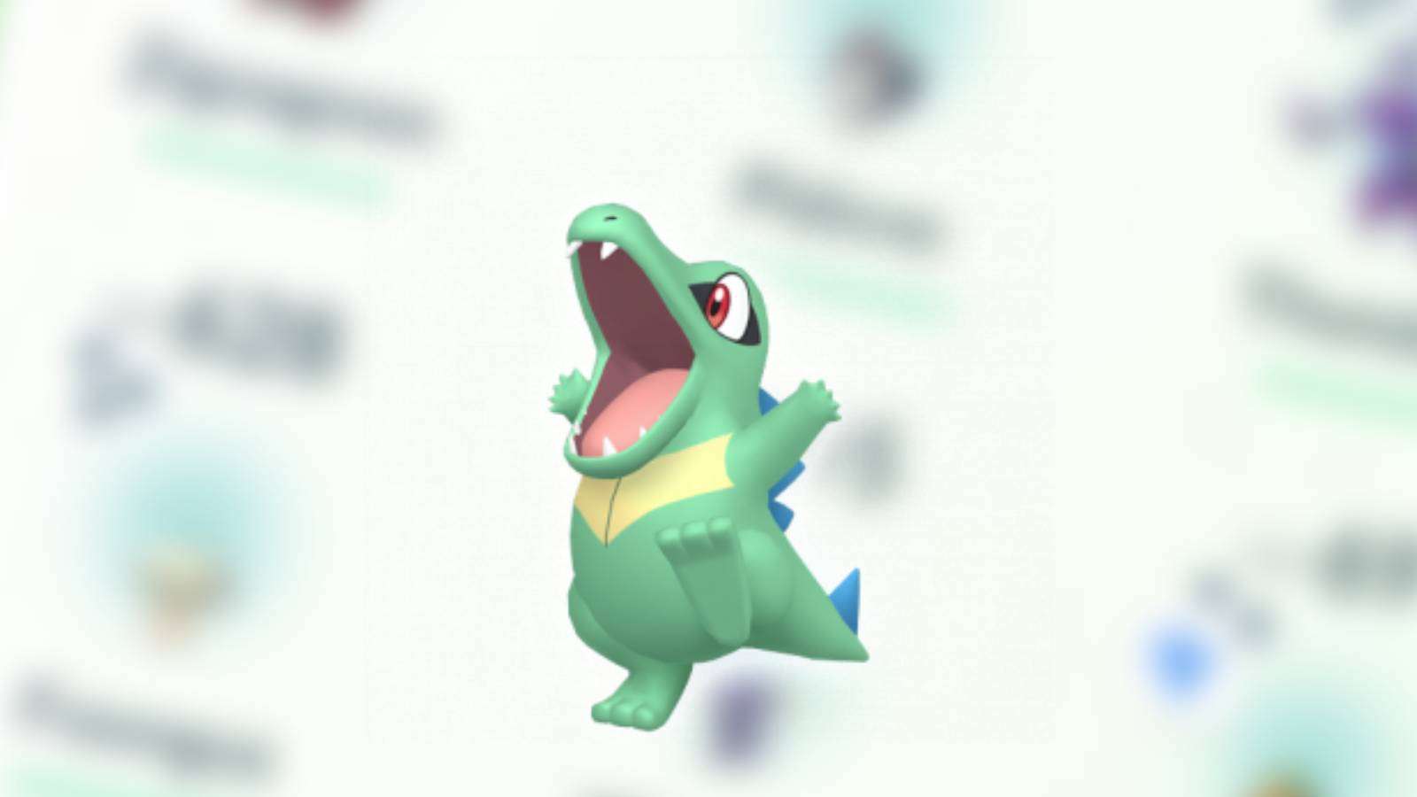 A Shiny Totodile sits in the center of the image, while a blurred image of several Shiny Pokemon is placed in the background