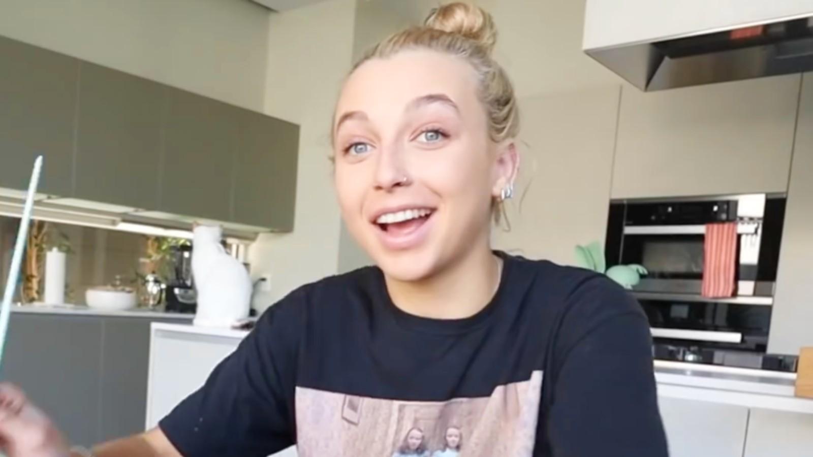 Emma Chamberlain smiles, looking at the camera in a YouTuber video
