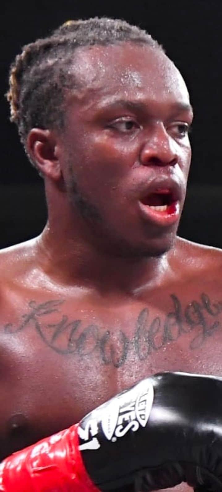 KSI wearing 'Prime' chain in boxing ring with Tommy Fury