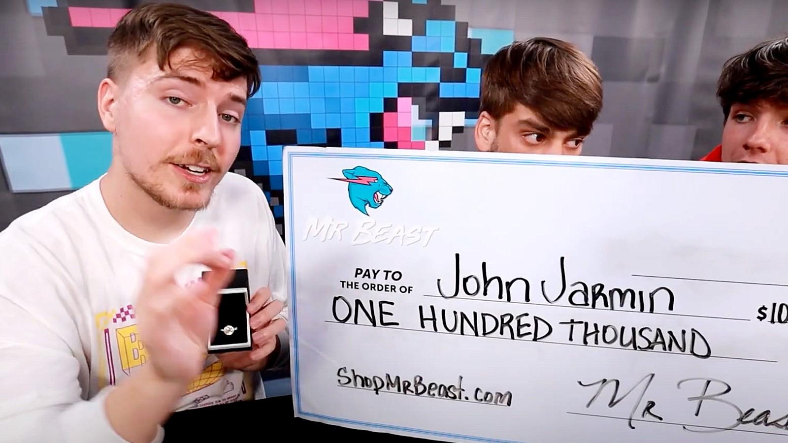Mr Beast and friends next to a cheque