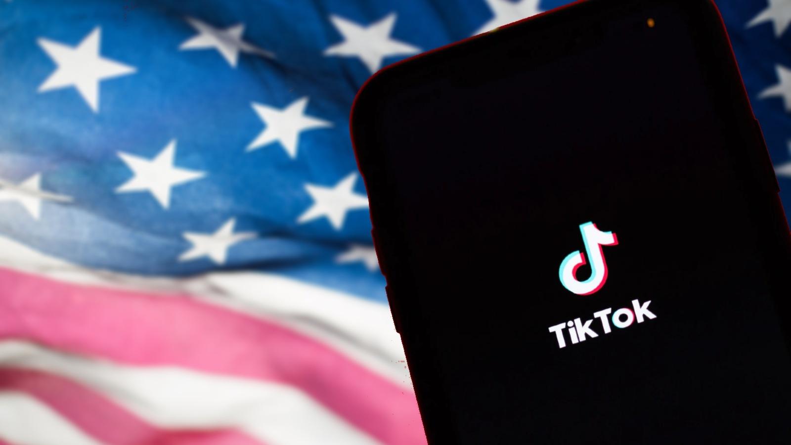 TikTok on a phone in front of US flag