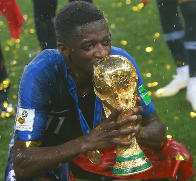 Ousmane Dembele holding the World Cup