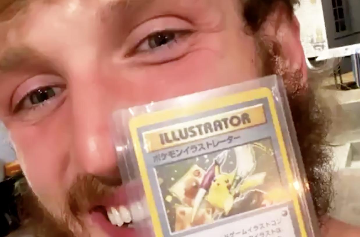 logan paul holding a pokemon card