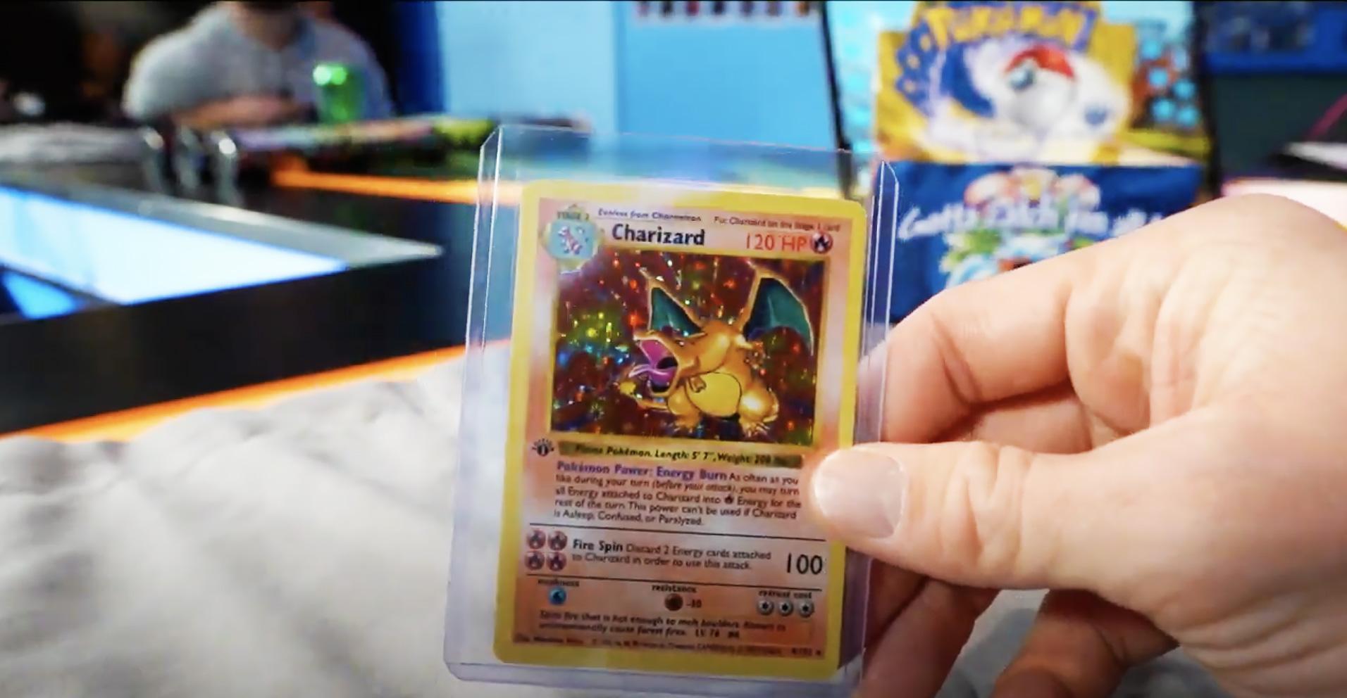 Logan Paul pulling a rare Charizard Pokemon card