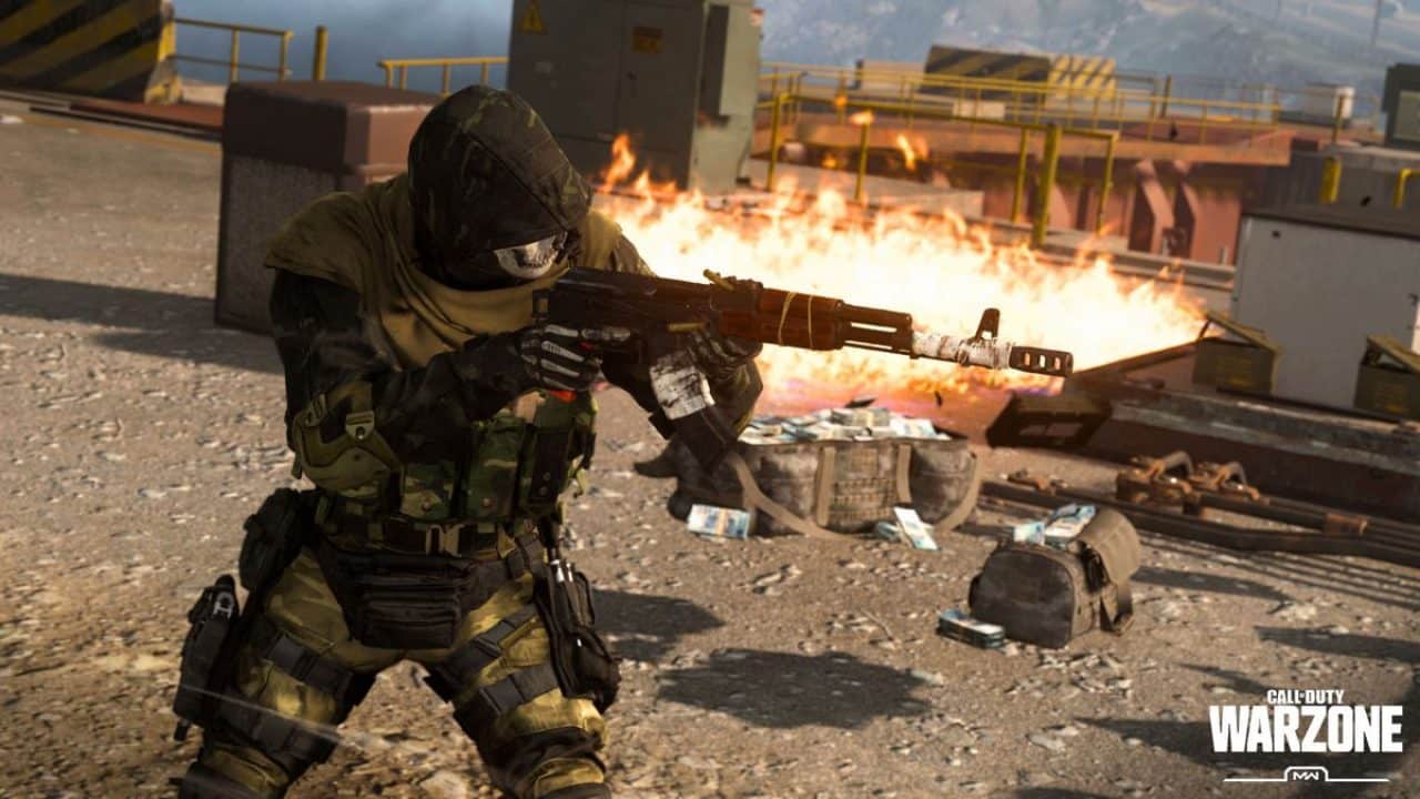 A soldier firing their weapon with fire in the background in Call of Duty Warzone