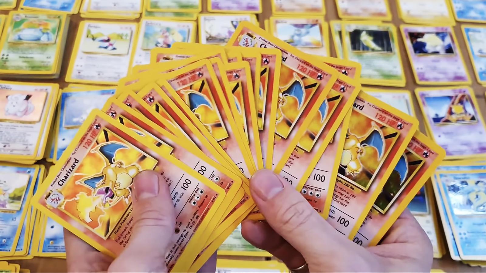 Screenshot of YouTuber holding up 111 Charizard Pokemon cards.