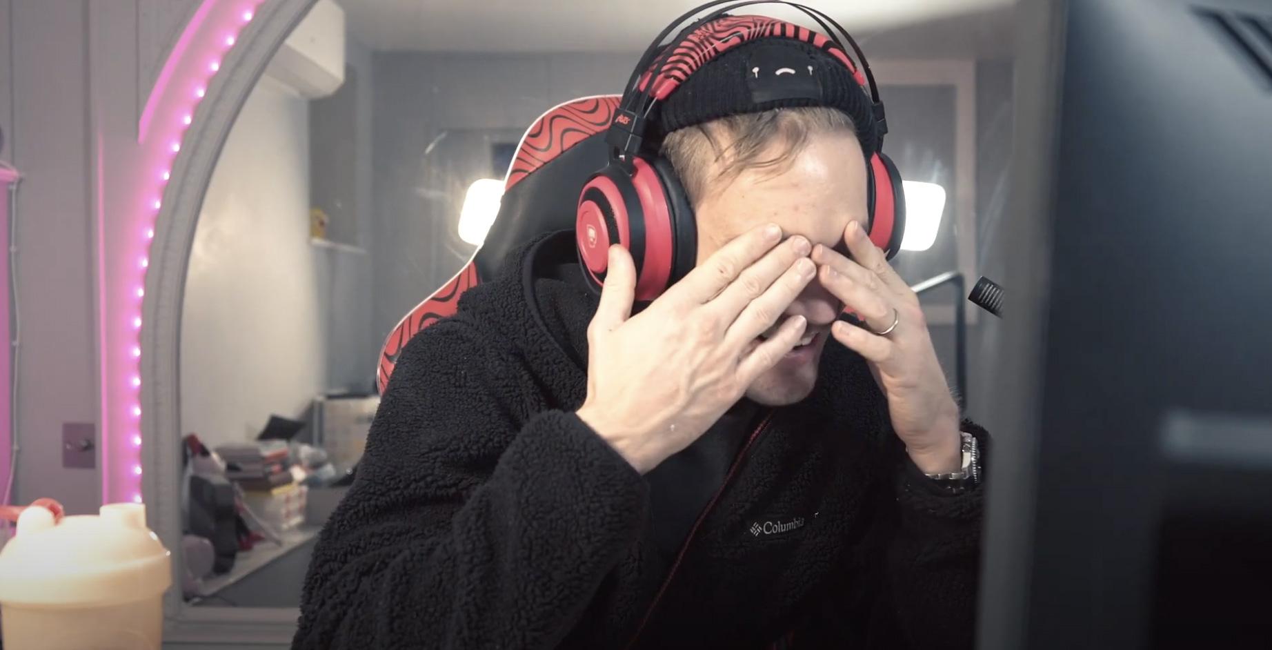 YouTuber PewDiePie with his hands over his face.