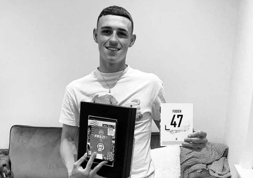 Phil Foden holding FIFA 21 