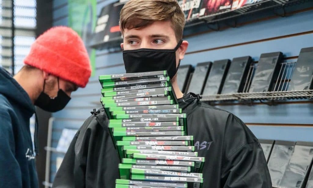 mrbeast holding pile of games at gamestop