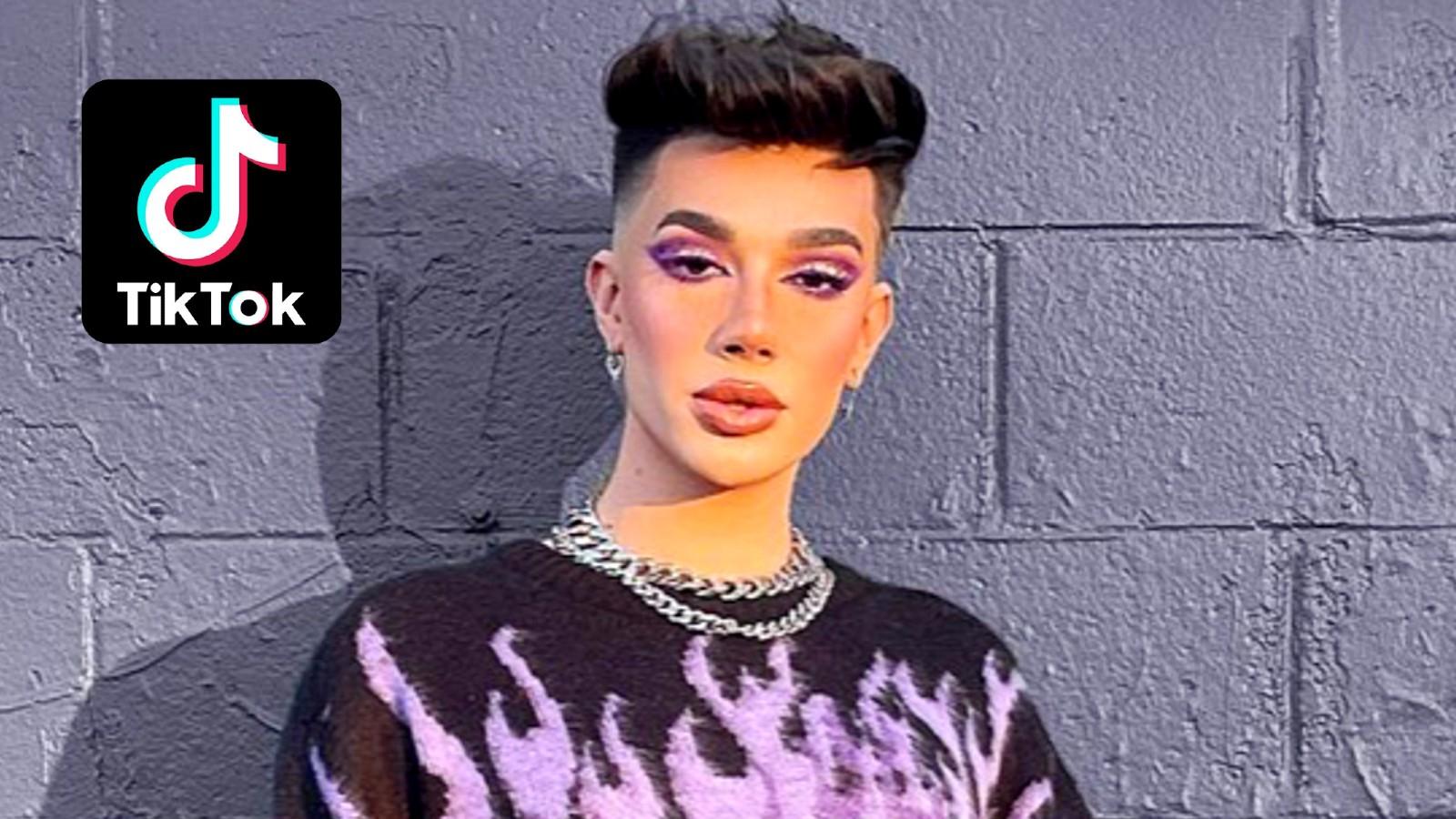 James Charles stands against a purple wall
