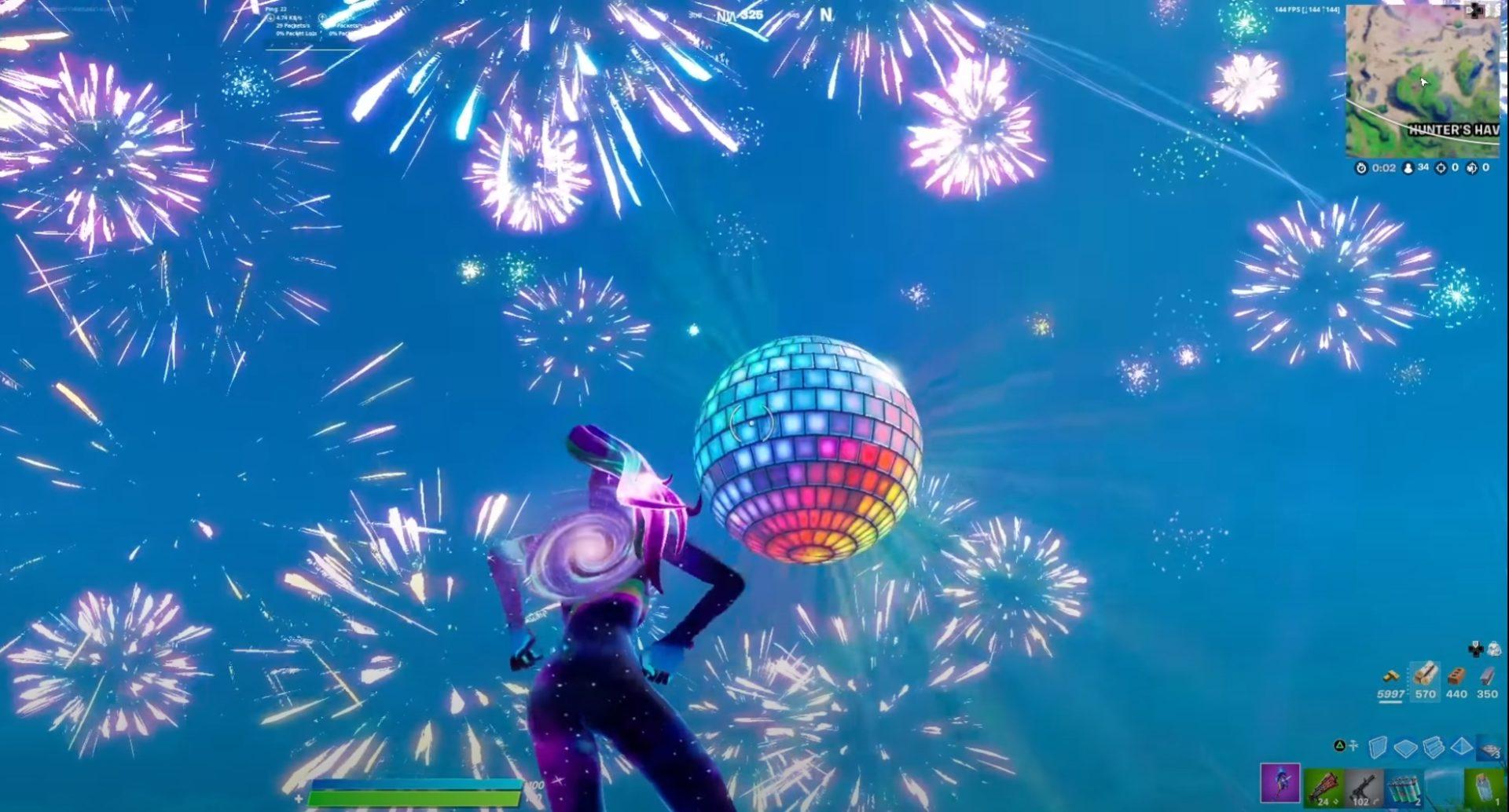 Fortnite's 2021 event with fireworks in the sky and a giant disco ball