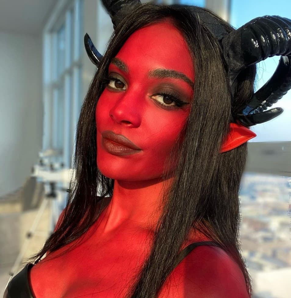 Sydeon poses in red paint and horns