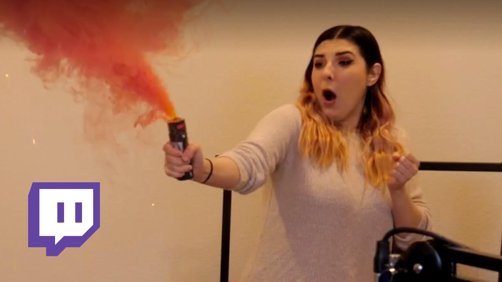 Twitch streamer holds smoke grenade with shocked face