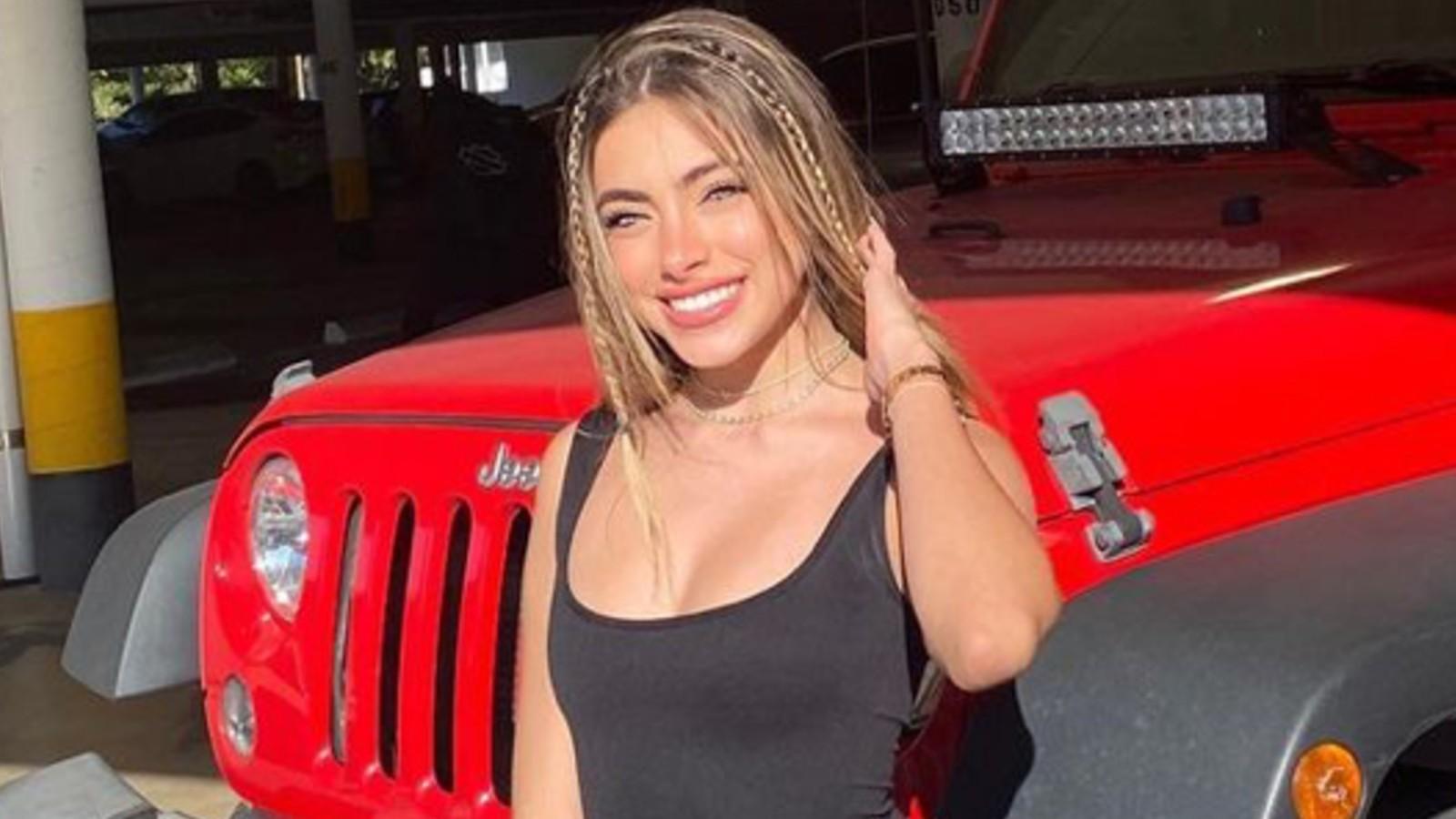 Valeria Arguelles poses in front of a car