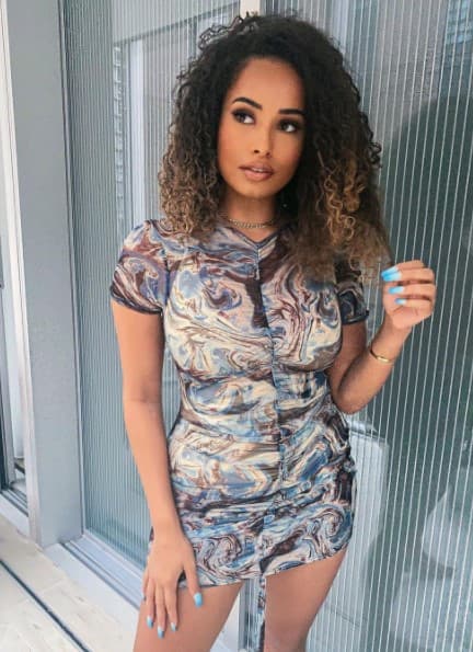 Amber Rose Gill standing next to a window for a photo
