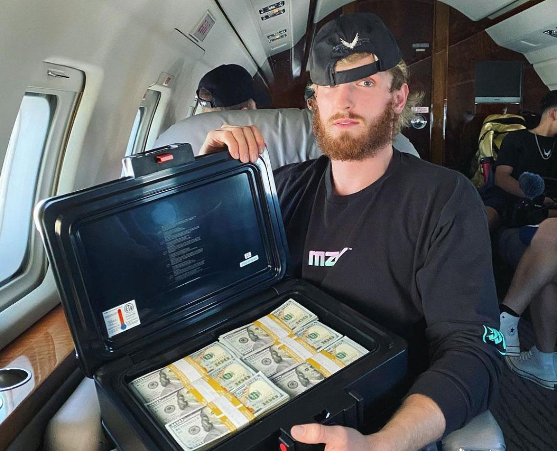 logan paul with suitcase of money