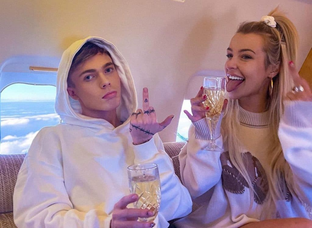 Cole Carrigan and Tana Mongeau drinking on a private jet