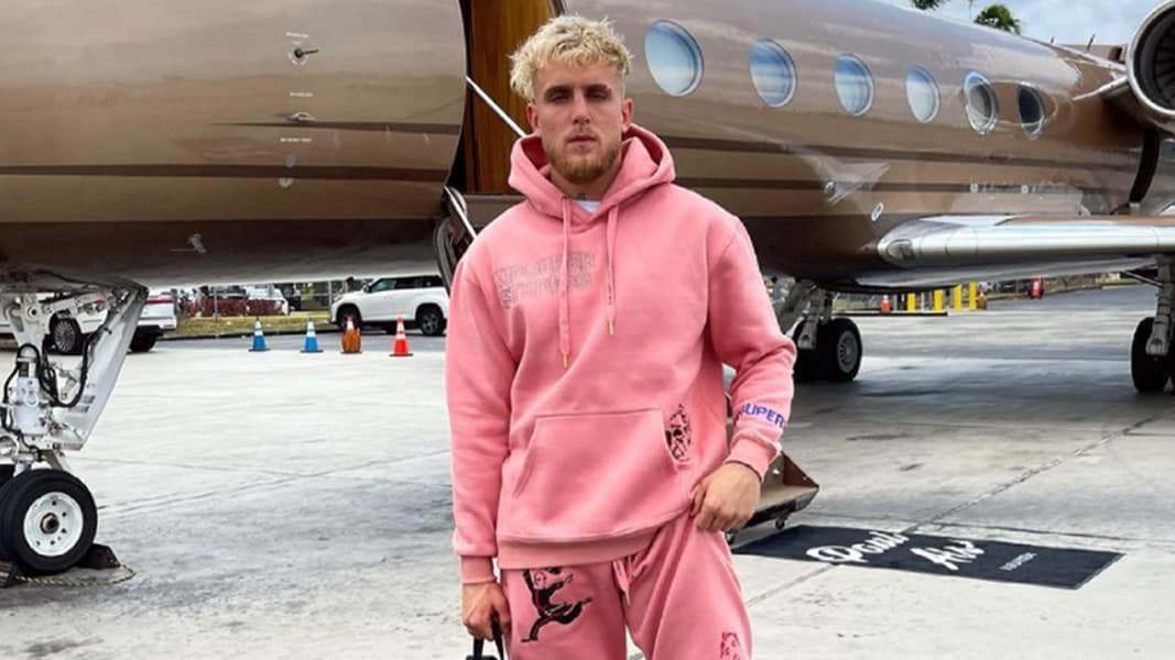 Jake Paul stood in front of a plane