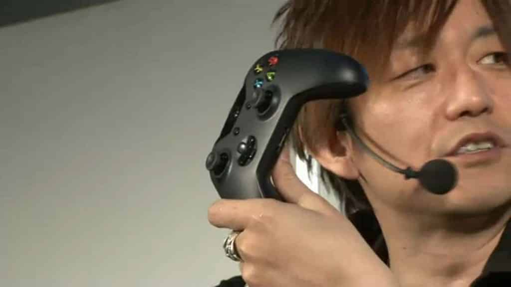 Yoshi P holds xbox controller