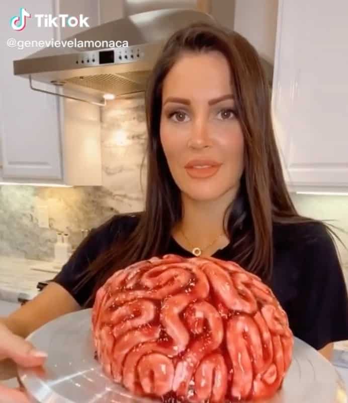 TikTok user holds a cake that looks like a brain