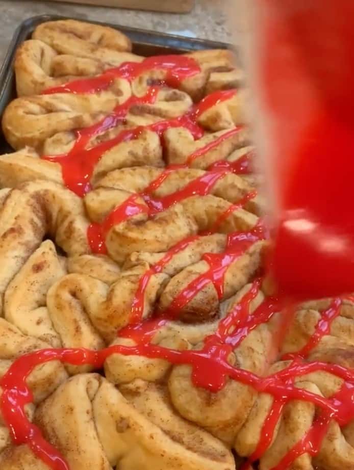 Cinnamon rolls covered with red icing