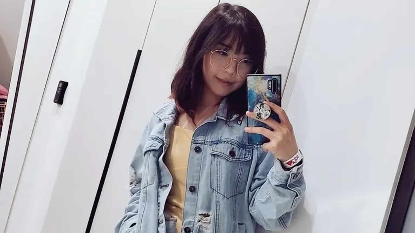 Twitch streamer Lilypichu taking a mirror selfie in a denim jacket and yellow dress