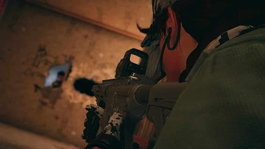 Rainbow Six Siege image showing an Operator shooting through a wall