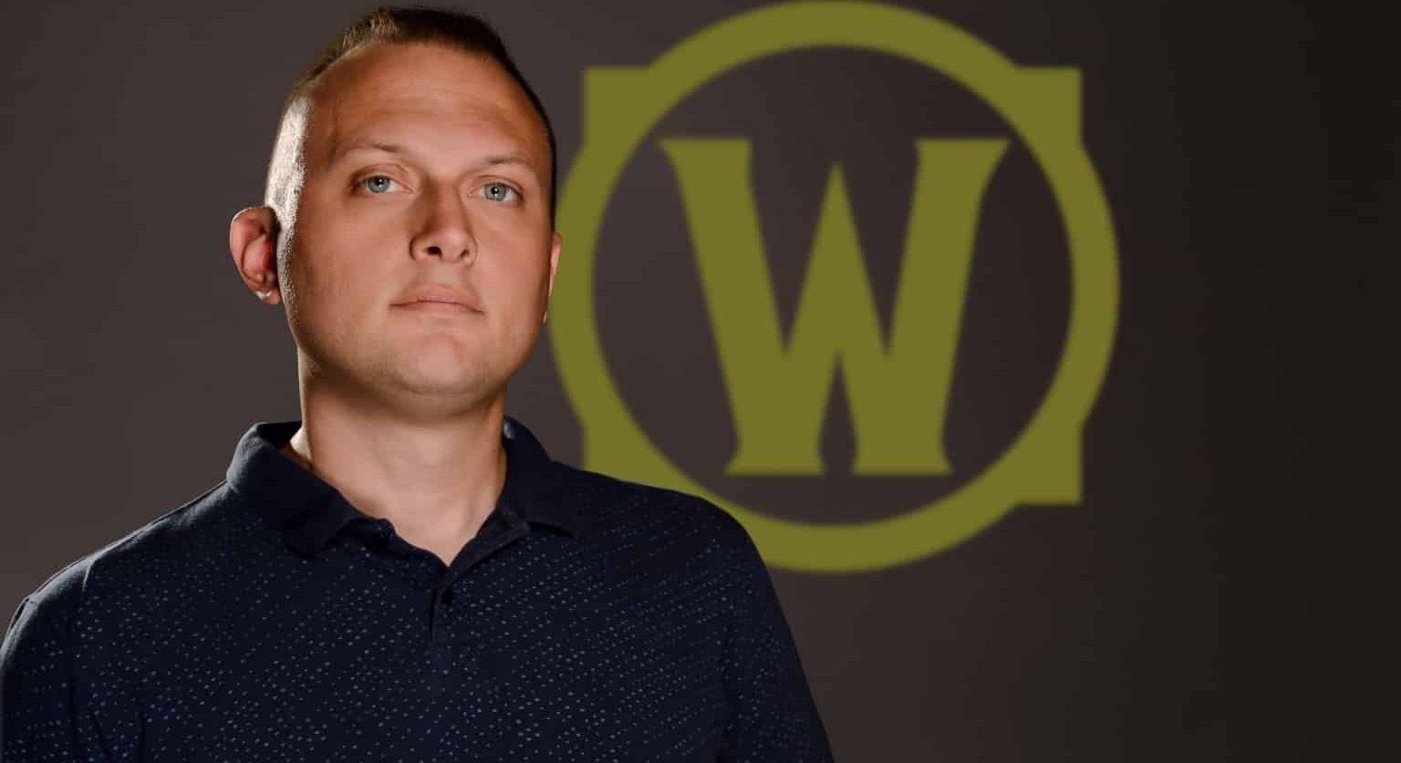 Man stands in front of World of Warcraft logo