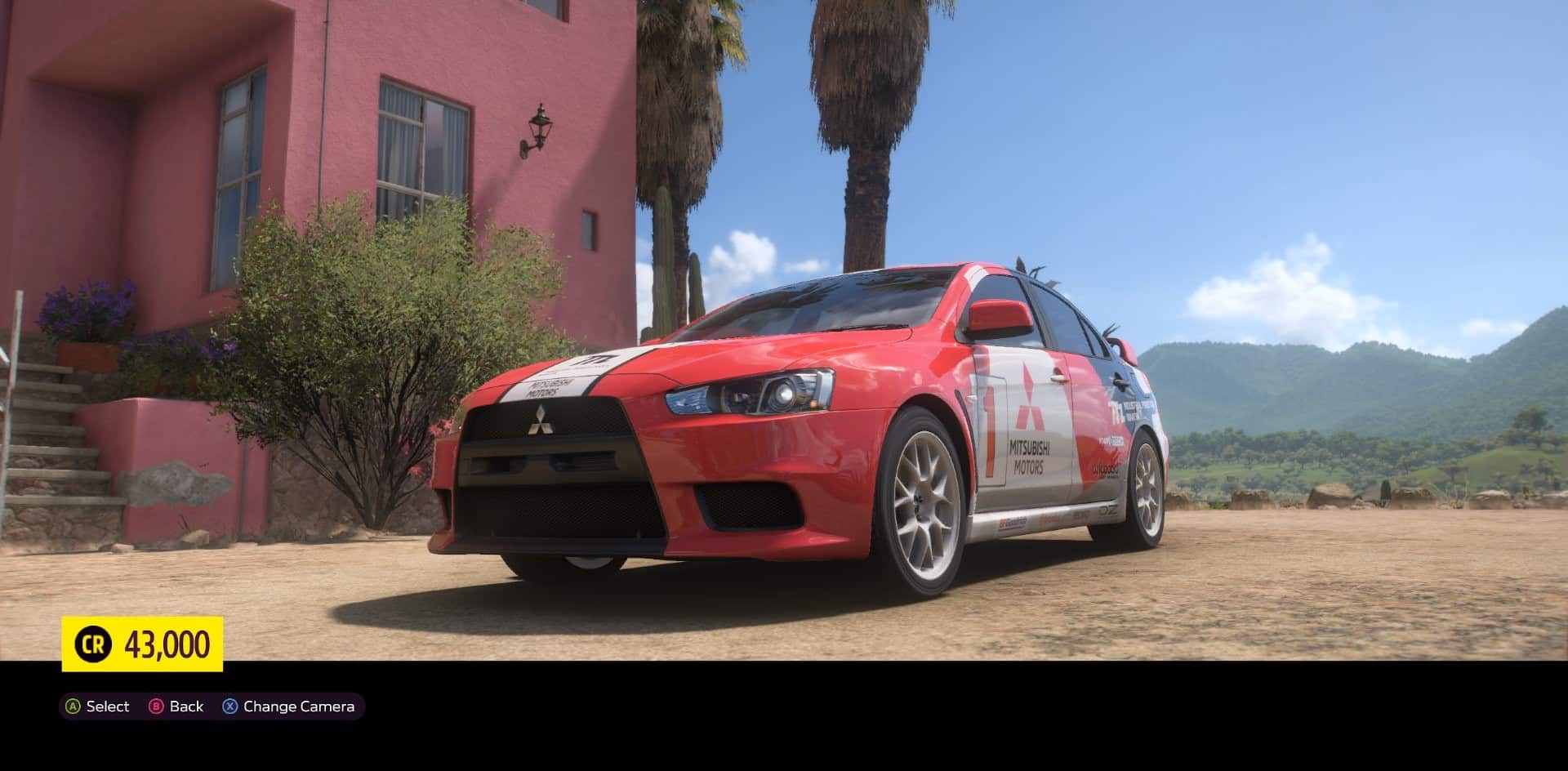 The Mitsubishi Lancer Evo, one of the best rally cars, sits on open ground in Forza Horizon 5