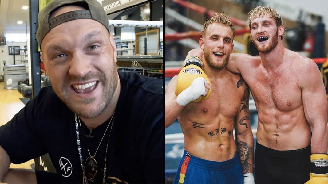 Tyson Fury talking to camera with Jake and Logan Paul inside boxing ring
