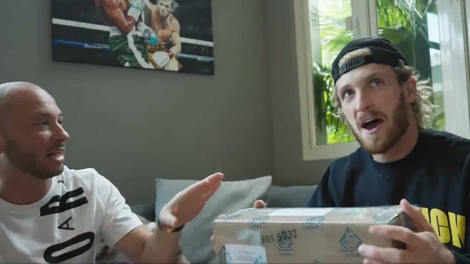 YouTuber Logan Paul holding Pokemon Card box he paid 3.5 million for