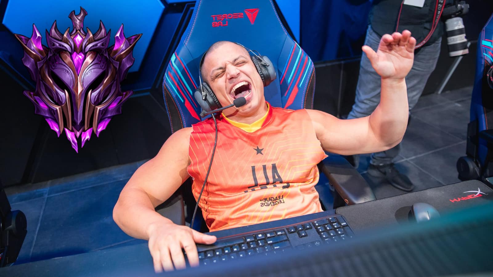 twitch streamer tyler 1 at an all stars league of legends lol event punches the air with master rank icon