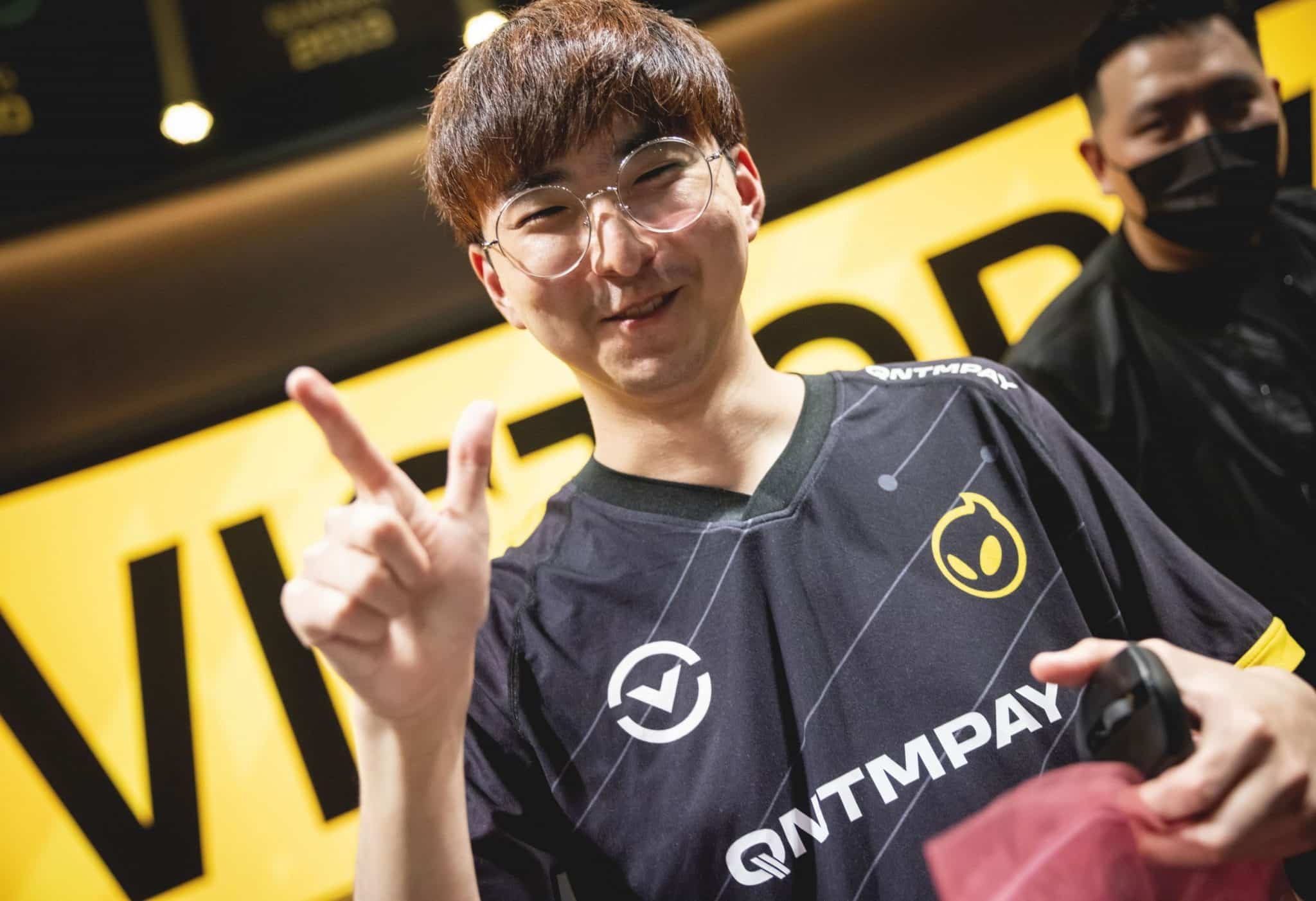 River flashing peace sign on LCS stage wearing Dignitas jersey
