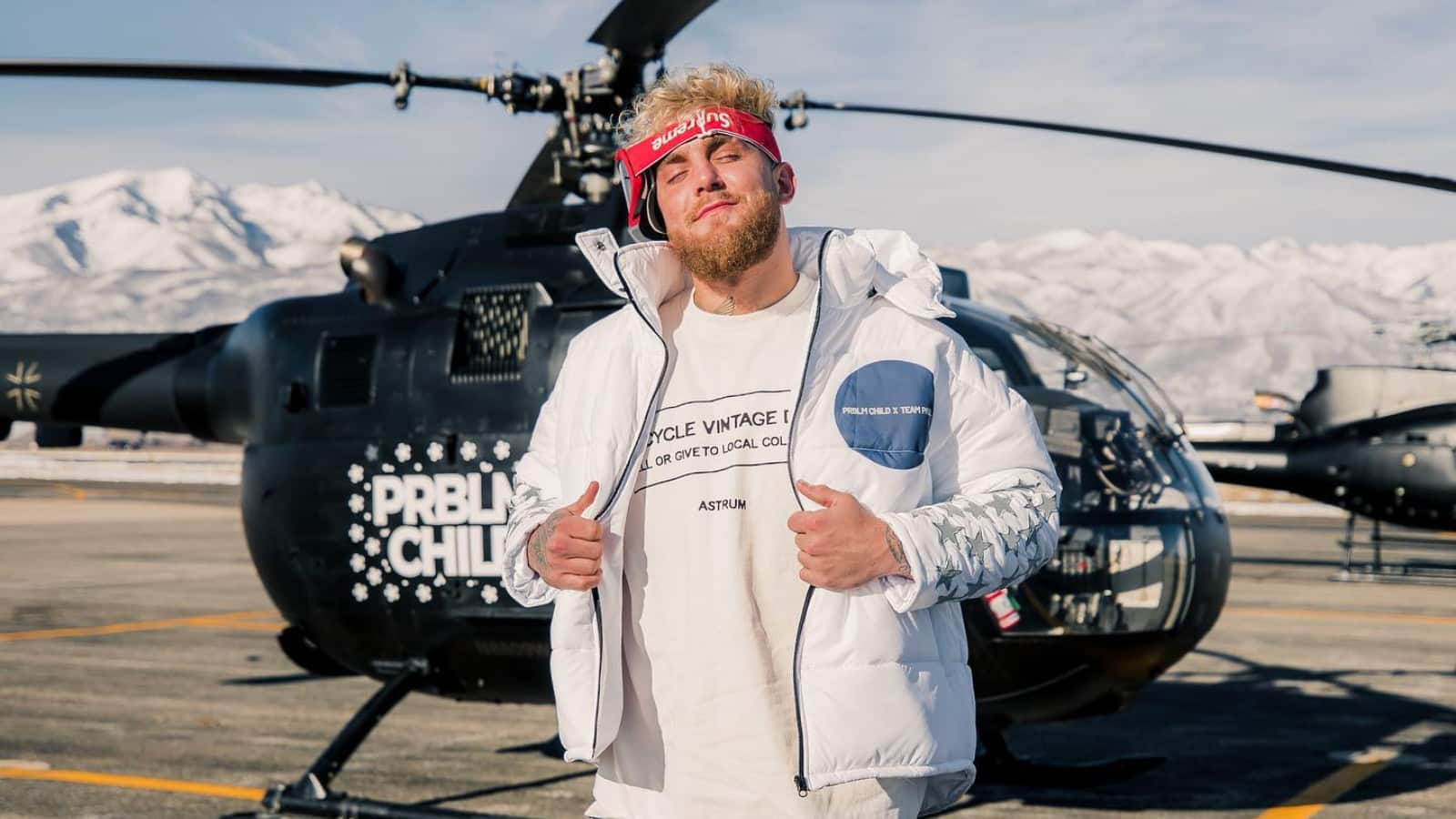 Jake Paul posing in front of PRBLM CHILD helicopter