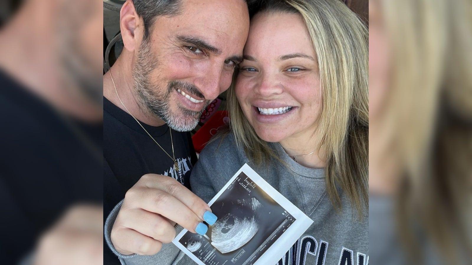 Trisha and Moses holding baby scan