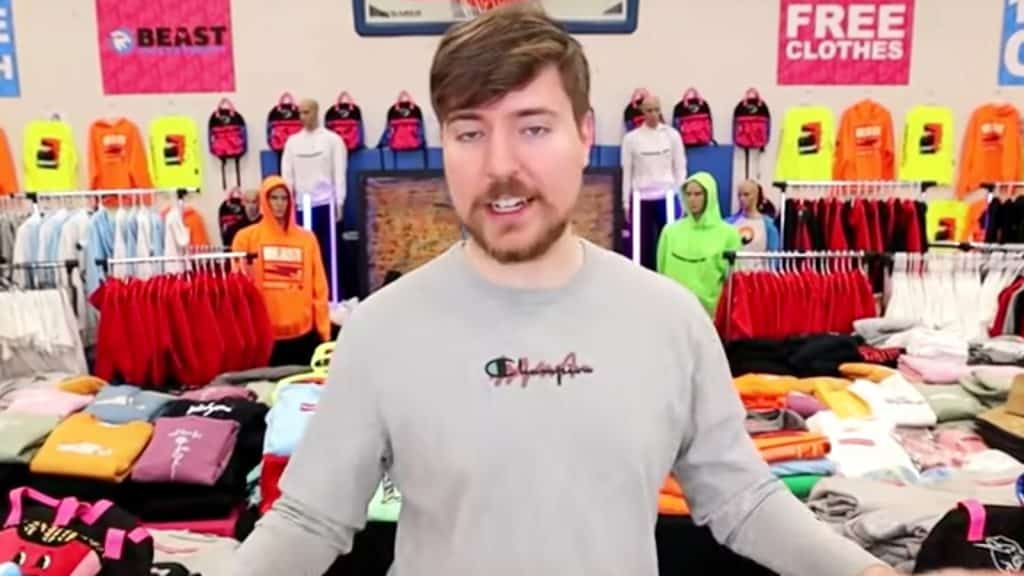 MrBeast stands in front of merch