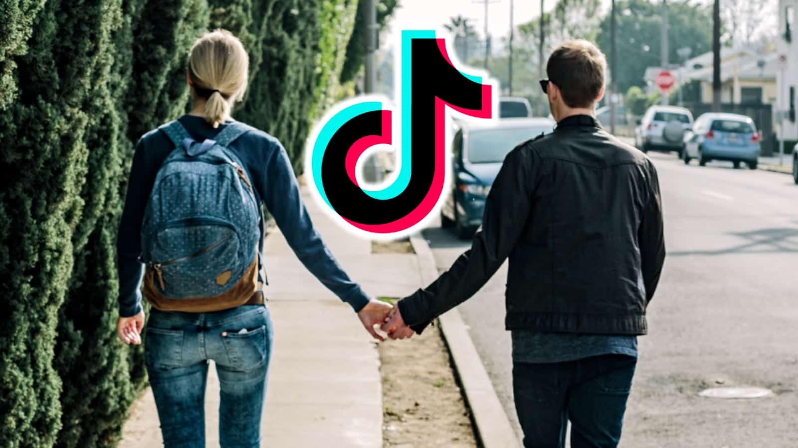 Couple holding hands on the sidewalk with the TikTok logo