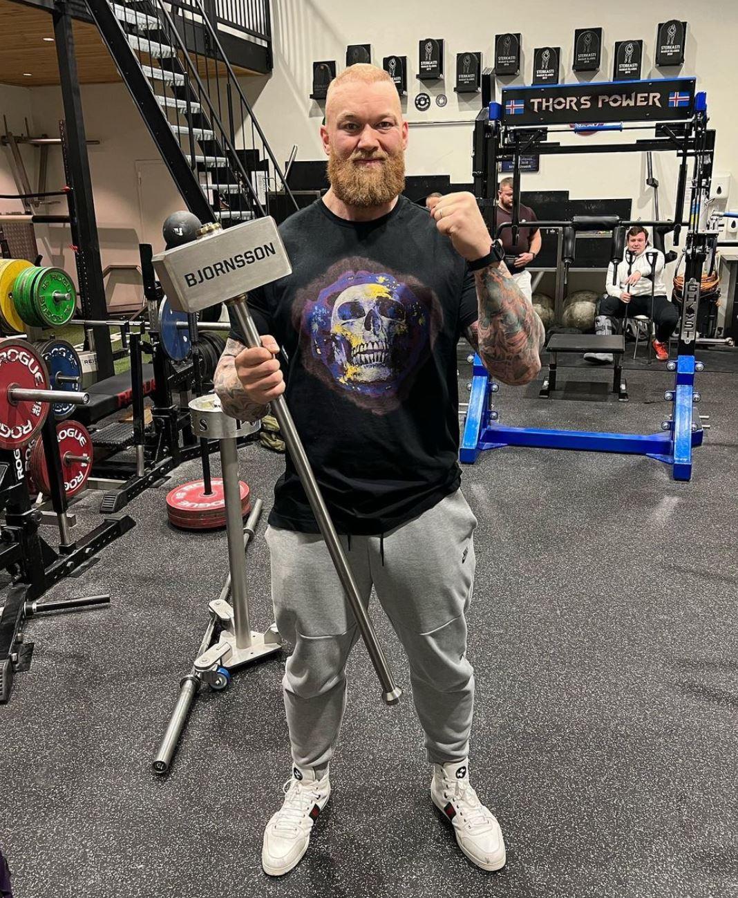 thor bjornsson with hammer in gym