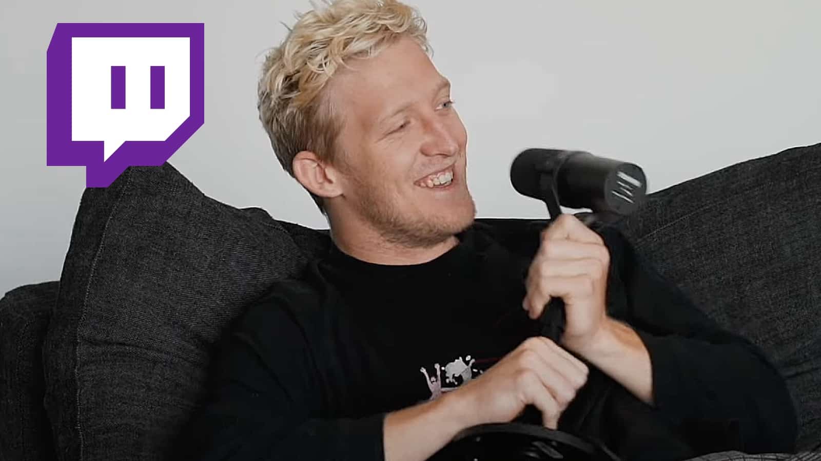 tfue holding microphone with twitch logo in top left corner