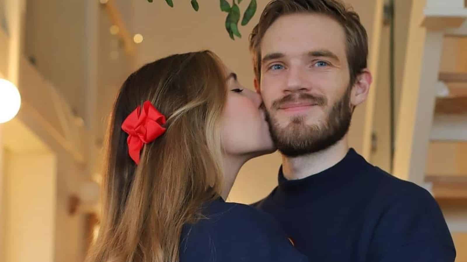 PewDiePie and his wife Marzia kissing his cheek
