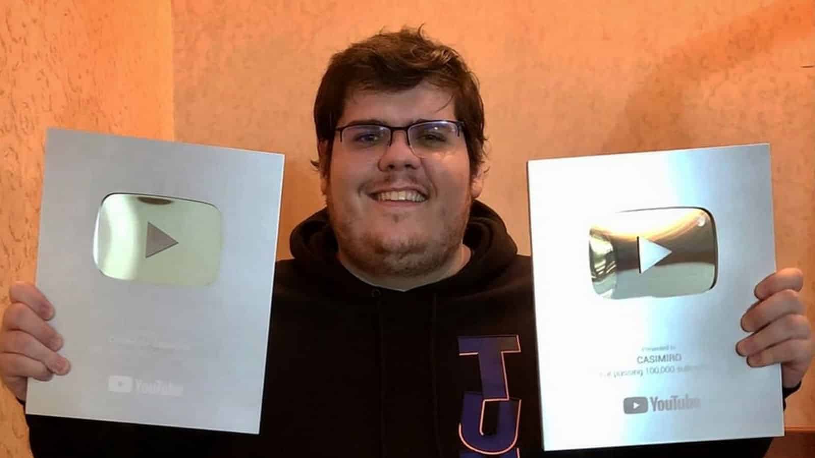 Twitch streamer Casimiro with two YouTube 100k subscriber playbutton plaques