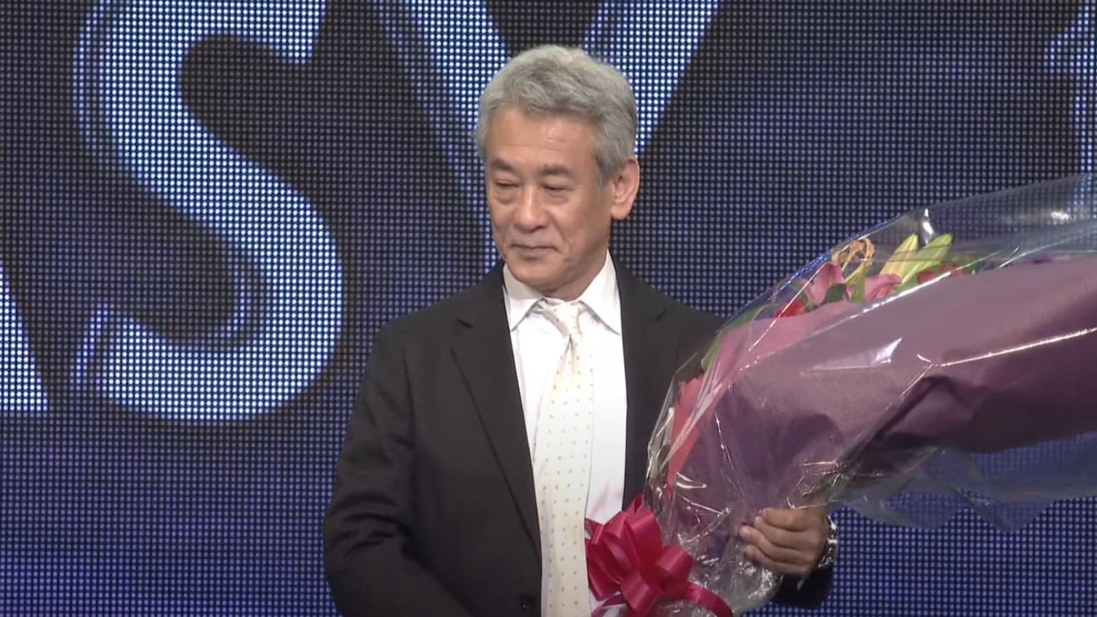 Shinji Hashimoto carrying flowers