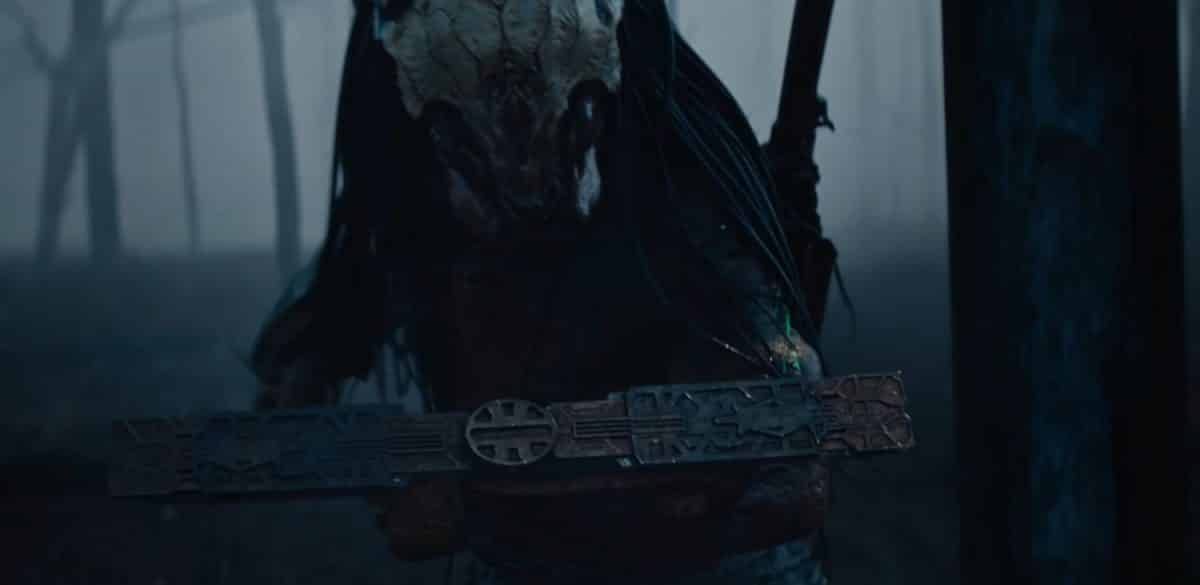 the Predator wearing anew helmet in the woods in its prequel Prey