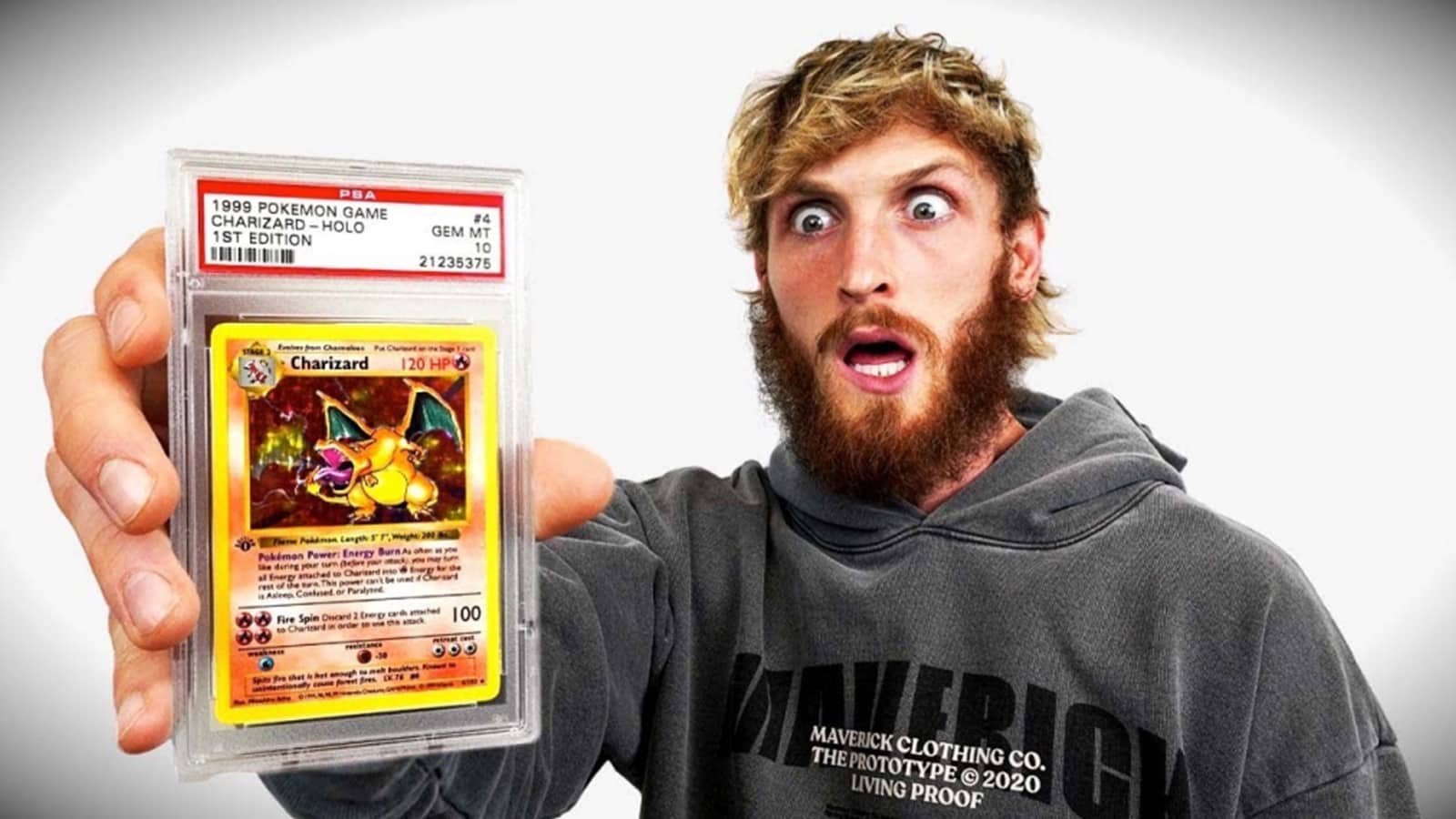 Logan Paul holds up charizard card