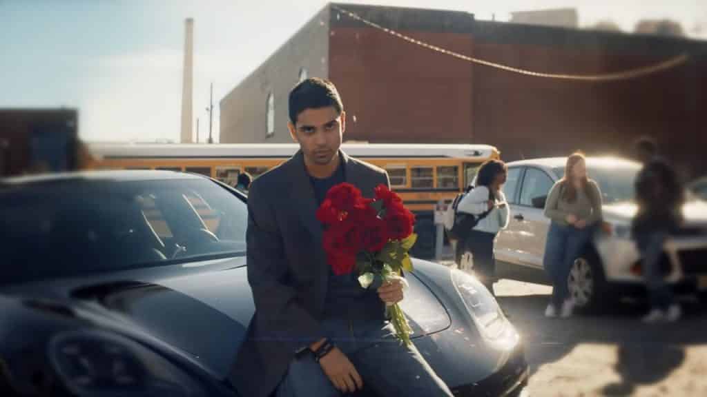 Kamran stands at his car with roses in ms marvel